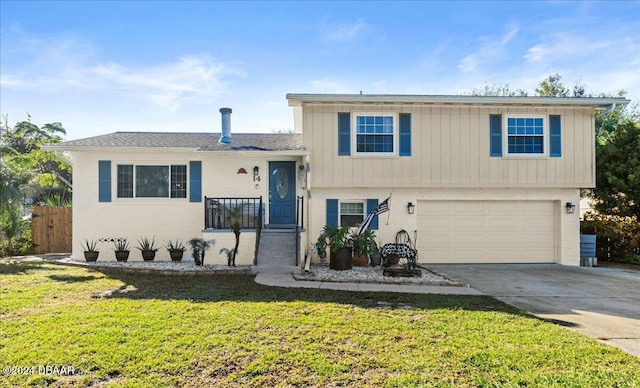 split level home featuring a front yard and a garage