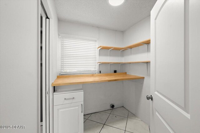 clothes washing area featuring a textured ceiling