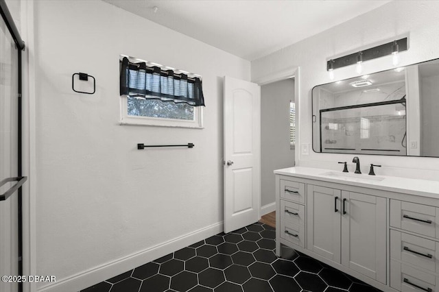 full bathroom featuring a shower stall, vanity, and baseboards