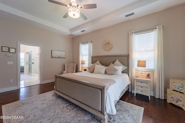 bedroom with ceiling fan, ensuite bathroom, and dark wood-type flooring