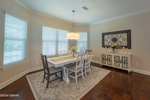 dining room with a chandelier, dark hardwood / wood-style floors, and ornamental molding