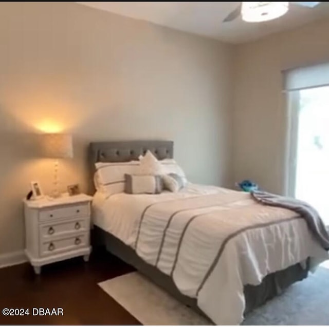 bedroom featuring ceiling fan and dark hardwood / wood-style flooring