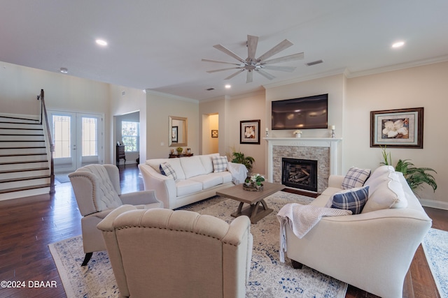 living room with french doors, crown molding, ceiling fan, and dark wood-type flooring