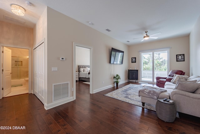 living room with ceiling fan and dark wood-type flooring