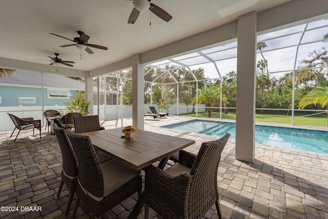 view of pool with ceiling fan, a patio area, and a lanai