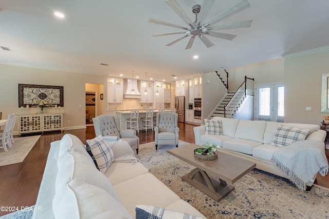 living room featuring ceiling fan, dark hardwood / wood-style flooring, and ornamental molding