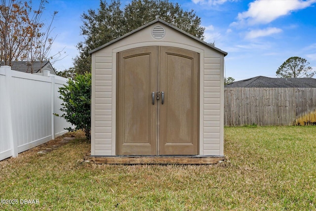 view of outbuilding featuring a lawn