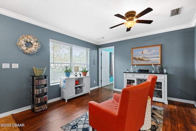 living area with ceiling fan, dark hardwood / wood-style flooring, and ornamental molding