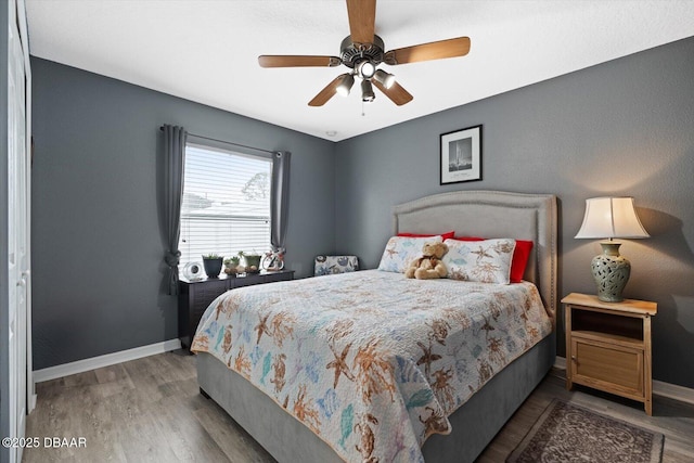 bedroom with ceiling fan and wood-type flooring