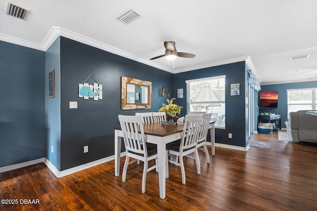 dining area featuring crown molding, dark hardwood / wood-style floors, and ceiling fan