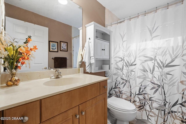 bathroom with toilet and vanity