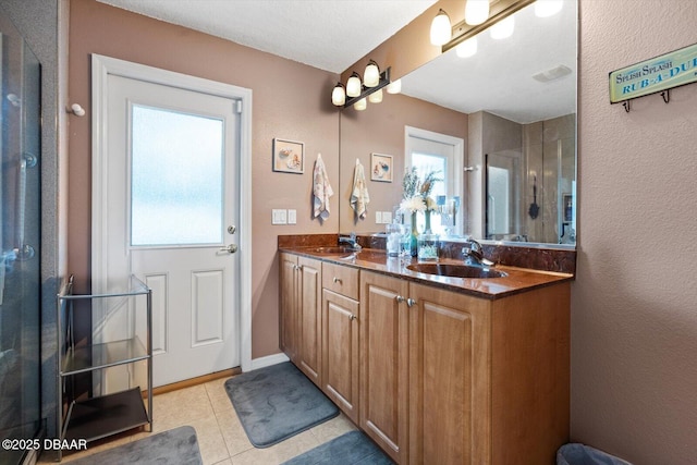 bathroom with plenty of natural light, tile patterned flooring, and vanity