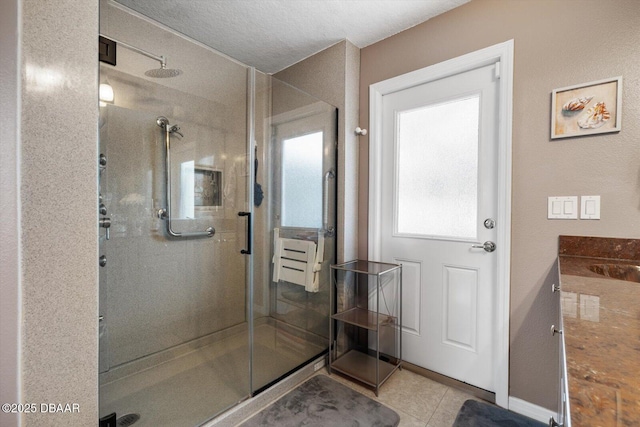 bathroom featuring vanity, walk in shower, and tile patterned flooring