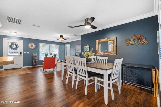 dining room featuring ceiling fan, ornamental molding, and dark hardwood / wood-style floors