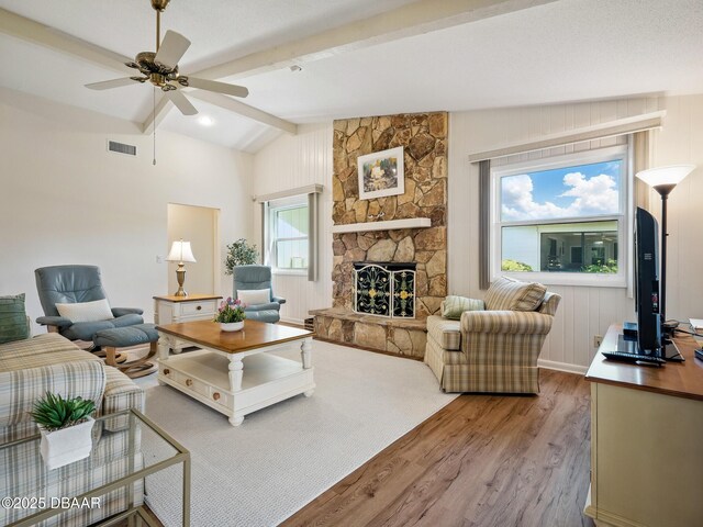 257 Sweet Bay Ave, New Smyrna Beach, FL 32168 - living area with light wood-style flooring, a ceiling fan, and a fireplace