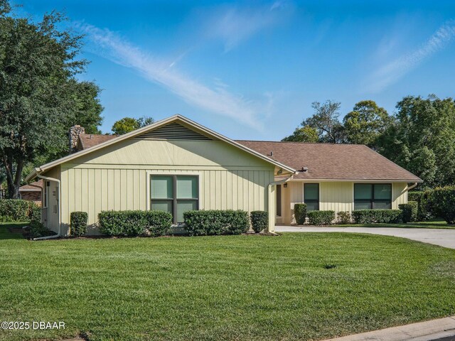 257 Sweet Bay Ave, New Smyrna Beach, FL 32168 - ranch-style home featuring a chimney and a front yard