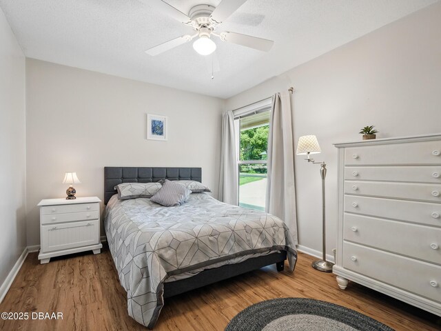 257 Sweet Bay Ave, New Smyrna Beach, FL 32168 - bedroom featuring wood finished floors, baseboards, access to exterior, and a ceiling fan