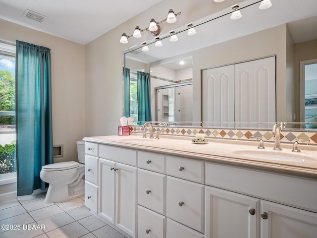 257 Sweet Bay Ave, New Smyrna Beach, FL 32168 - bathroom featuring a stall shower, tile patterned floors, toilet, double vanity, and tasteful backsplash
