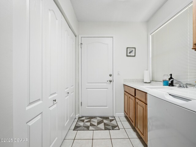 257 Sweet Bay Ave, New Smyrna Beach, FL 32168 - laundry area with washer / dryer, light tile patterned floors, and a sink