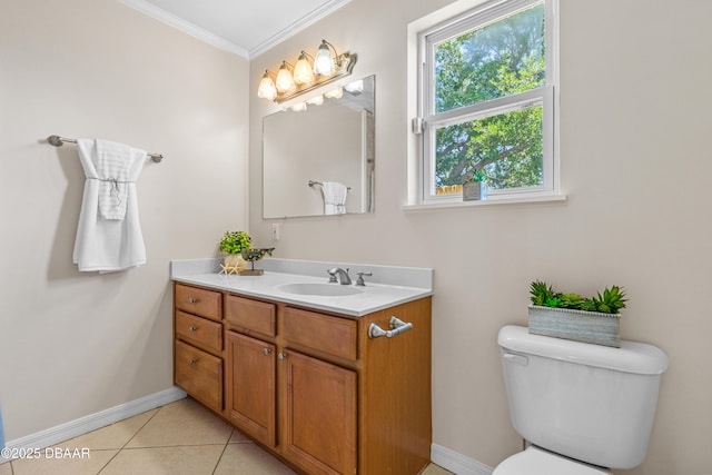 bathroom with crown molding, baseboards, vanity, toilet, and tile patterned flooring