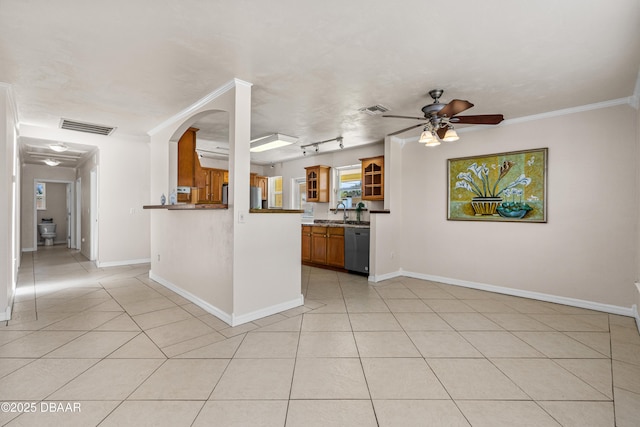 kitchen with stainless steel dishwasher, light tile patterned flooring, ceiling fan, brown cabinets, and crown molding