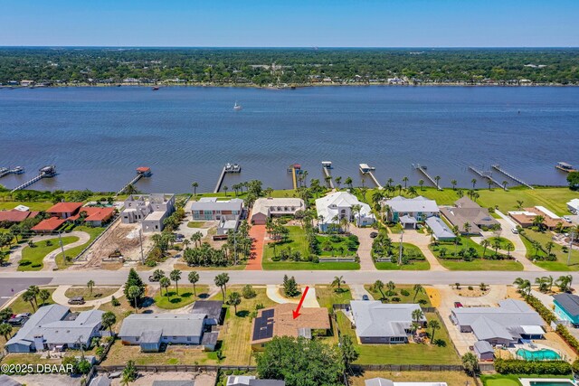 aerial view of property and surrounding area with a nearby body of water and nearby suburban area