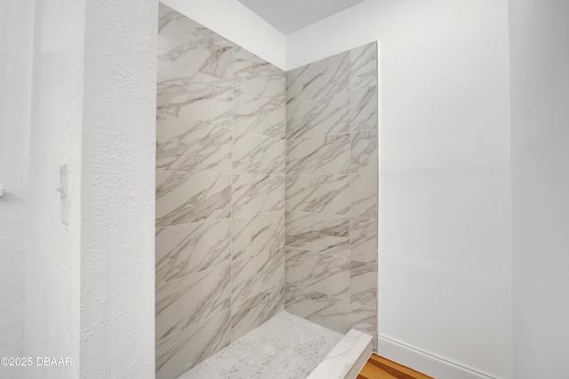 bathroom featuring tiled shower