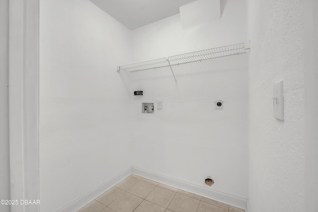 washroom featuring light tile patterned flooring, washer hookup, and hookup for an electric dryer