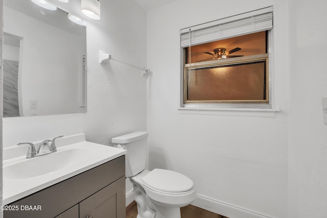 bathroom with vanity, toilet, and ceiling fan