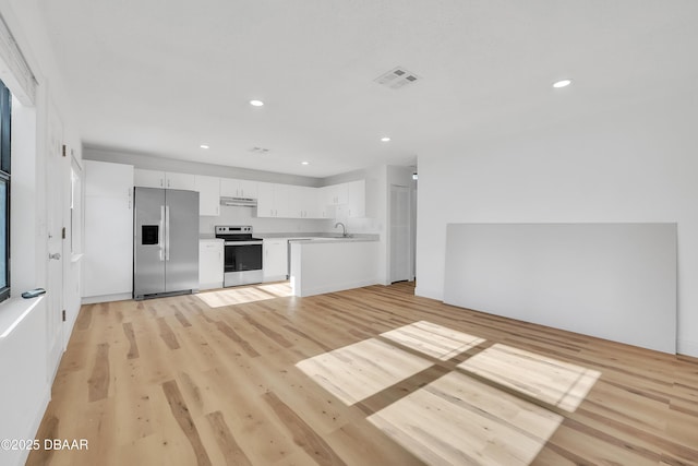 kitchen with white cabinets, sink, stainless steel refrigerator with ice dispenser, range with electric stovetop, and light wood-type flooring