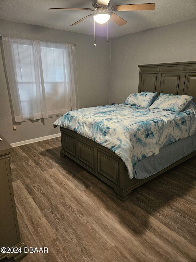 bedroom featuring ceiling fan and dark hardwood / wood-style floors