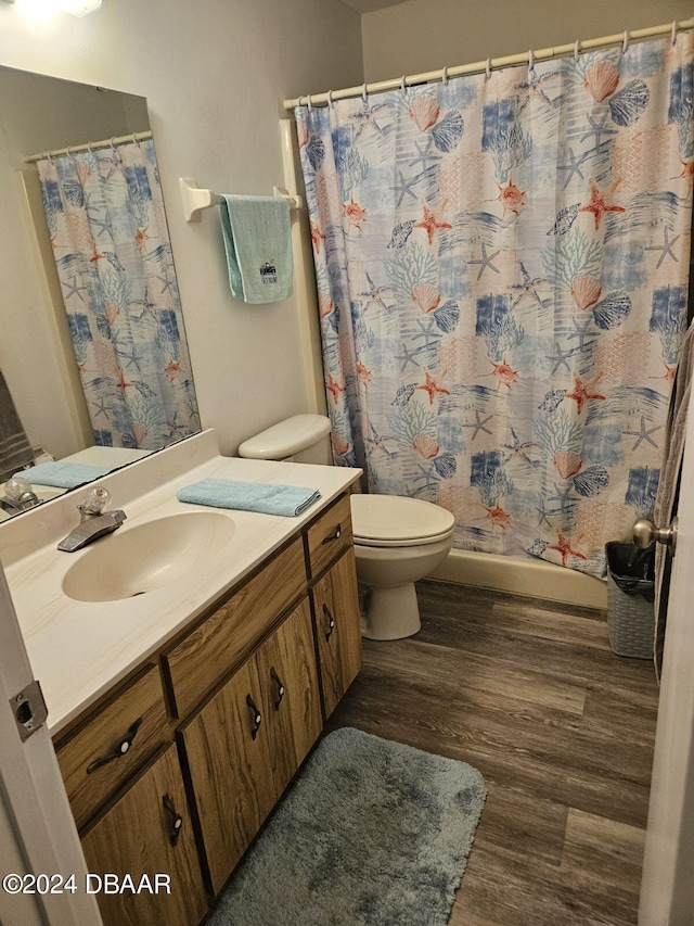 bathroom with vanity, hardwood / wood-style flooring, toilet, and a shower with curtain