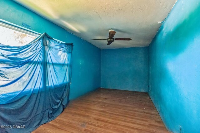 4519 Saxon Dr, New Smyrna Beach, FL 32169 - empty room featuring wood finished floors, ceiling fan, and a textured ceiling
