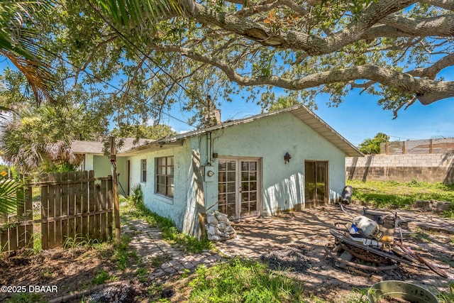 4519 Saxon Dr, New Smyrna Beach, FL 32169 - rear view of property featuring stucco siding and a chimney