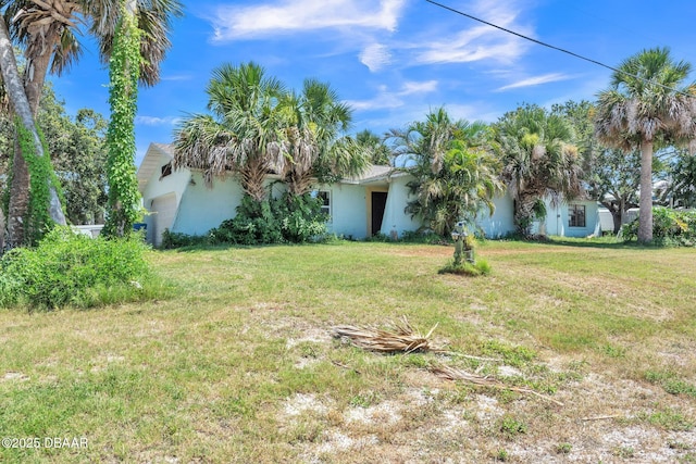 4519 Saxon Dr, New Smyrna Beach, FL 32169 - view of green lawn featuring an attached garage