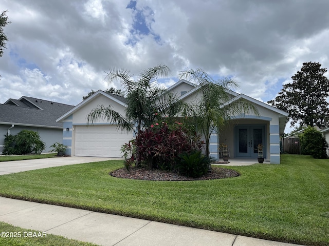 5988 Heron Pond Dr, Port Orange, FL 32128 - view of front facade with french doors, stucco siding, an attached garage, concrete driveway, and a front yard