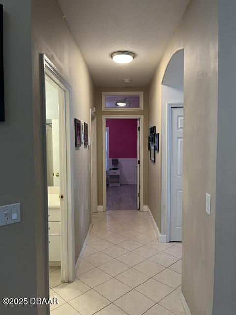 5988 Heron Pond Dr, Port Orange, FL 32128 - corridor featuring light tile patterned floors and baseboards