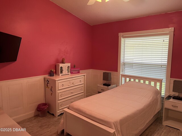 5988 Heron Pond Dr, Port Orange, FL 32128 - bedroom featuring light wood-style flooring, wainscoting, and ceiling fan
