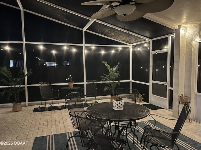 5988 Heron Pond Dr, Port Orange, FL 32128 - patio at night featuring a patio, glass enclosure, ceiling fan, and outdoor dining area