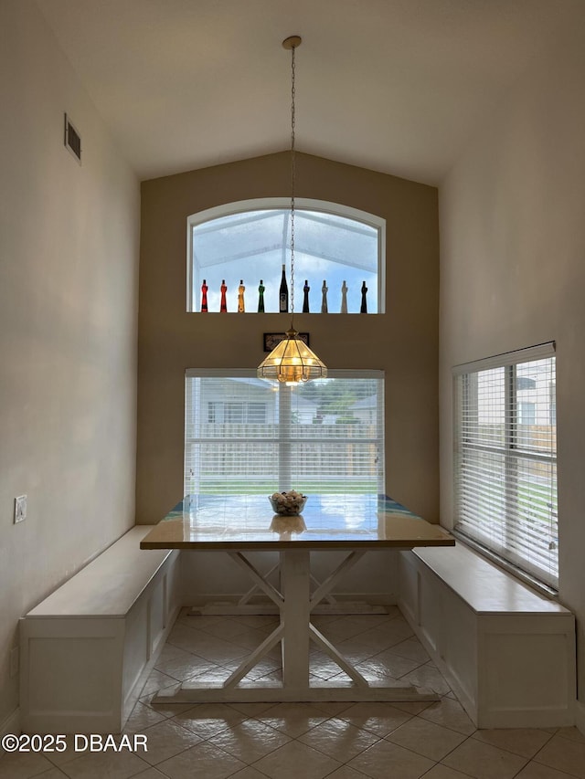 5988 Heron Pond Dr, Port Orange, FL 32128 - unfurnished dining area with light tile patterned floors, a chandelier, breakfast area, and high vaulted ceiling