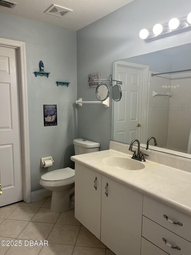 5988 Heron Pond Dr, Port Orange, FL 32128 - bathroom featuring vanity, tile patterned flooring, a shower, and a textured ceiling