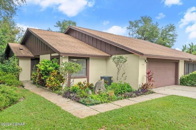 single story home featuring central AC unit, a garage, and a front yard