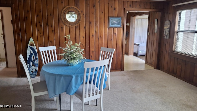 179 Ponce De Leon Dr, Ormond Beach, FL 32176 - dining space with carpet floors and wood walls
