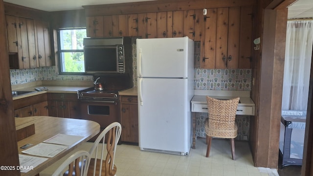 179 Ponce De Leon Dr, Ormond Beach, FL 32176 - kitchen with freestanding refrigerator, tasteful backsplash, light countertops, light flooring, and stainless steel electric stove