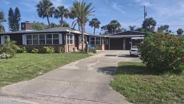 179 Ponce De Leon Dr, Ormond Beach, FL 32176 - ranch-style house featuring driveway, brick siding, a front lawn, a garage, and a chimney