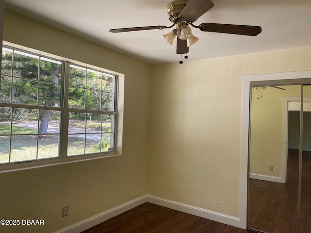660 S Ridgewood Ave, Ormond Beach, FL 32174 - empty room with plenty of natural light, dark wood-style floors, a ceiling fan, and a textured wall