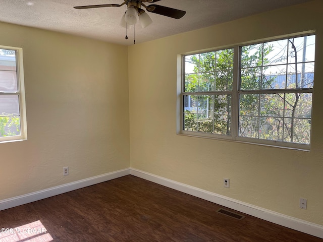 660 S Ridgewood Ave, Ormond Beach, FL 32174 - unfurnished room with plenty of natural light, dark wood-style floors, and ceiling fan