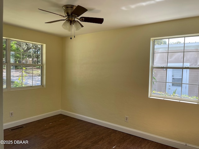 660 S Ridgewood Ave, Ormond Beach, FL 32174 - empty room featuring healthy amount of natural light, dark wood-style flooring, and ceiling fan