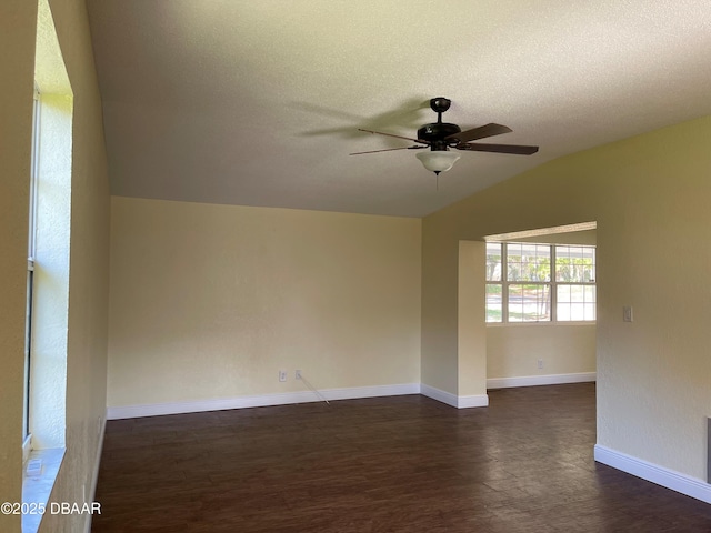 660 S Ridgewood Ave, Ormond Beach, FL 32174 - unfurnished room with a ceiling fan, lofted ceiling, dark wood-style flooring, and a textured ceiling
