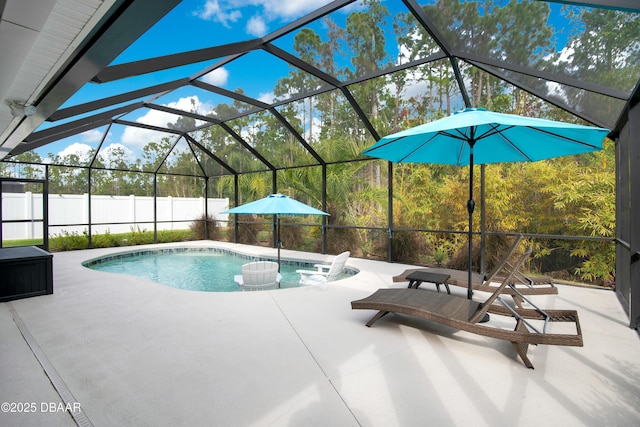 view of pool with glass enclosure and a patio